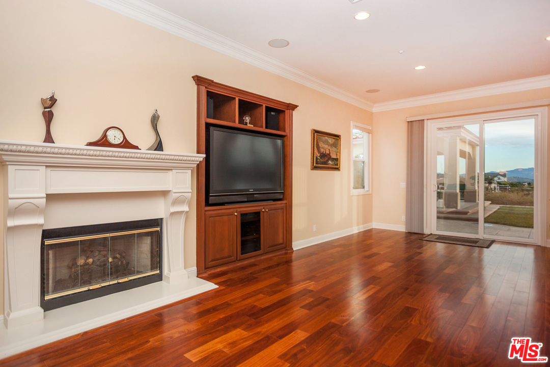 12090 Nelson Road Moorpark, CA 93021 - Photo 11 of 54 a living room with furniture a fireplace and a flat screen tv