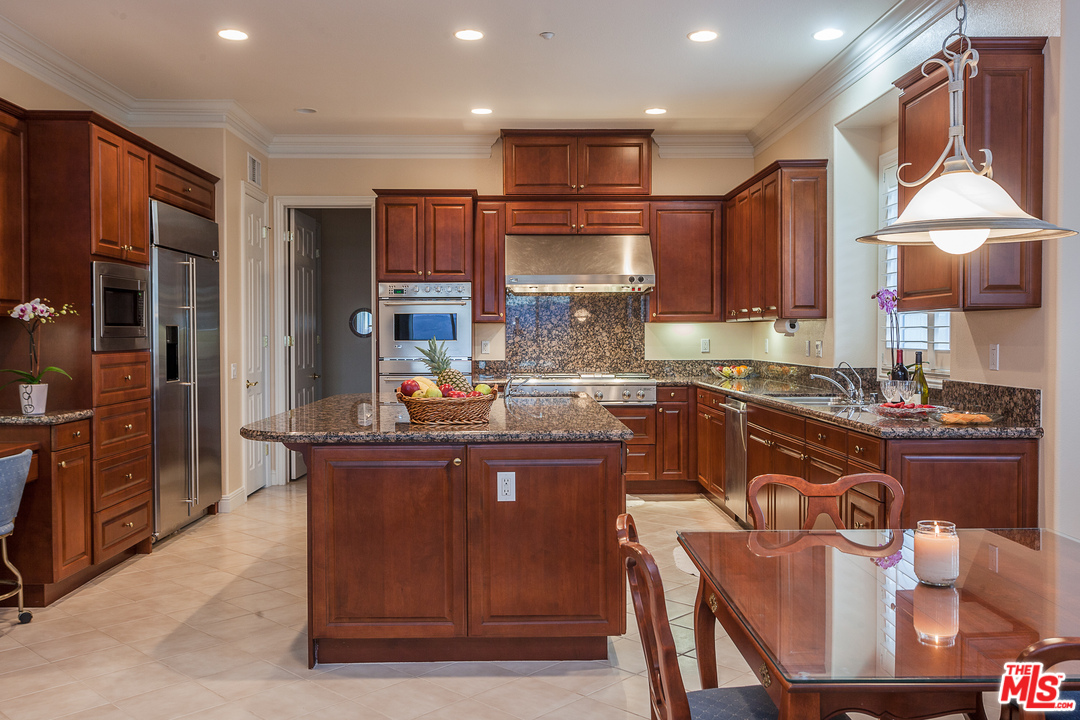 12090 Nelson Road Moorpark, CA 93021 - Photo 14 of 54 a kitchen with kitchen island granite countertop wooden cabinets and a stainless steel appliances