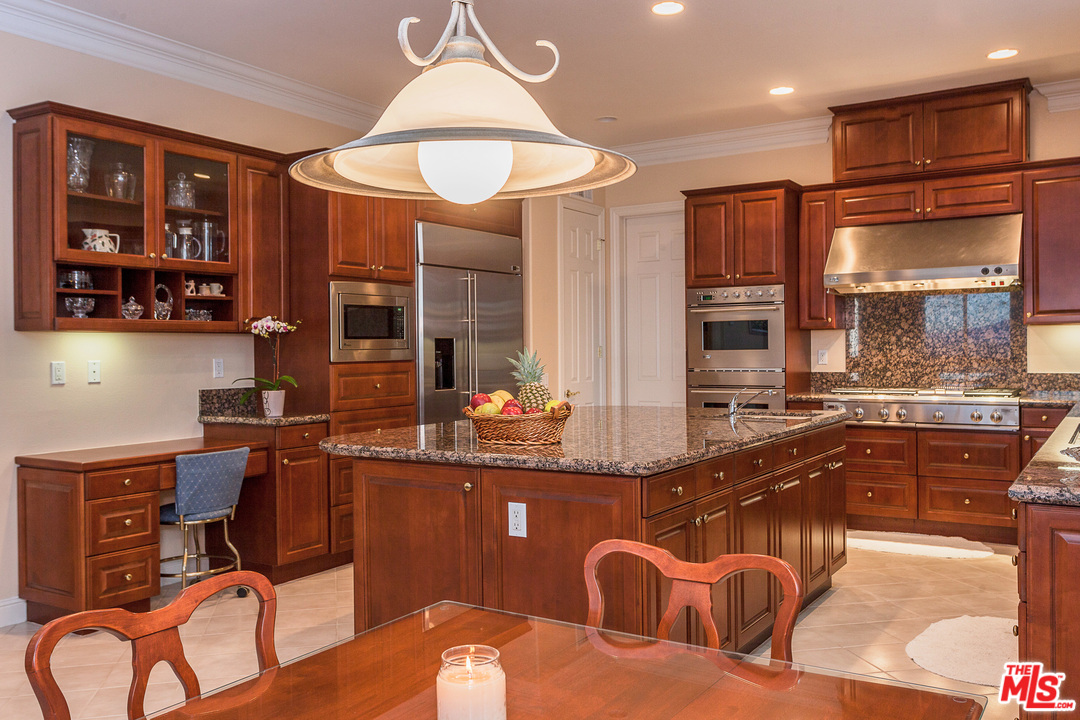 12090 Nelson Road Moorpark, CA 93021 - Photo 16 of 54 a kitchen with stainless steel appliances granite countertop a sink and a refrigerator