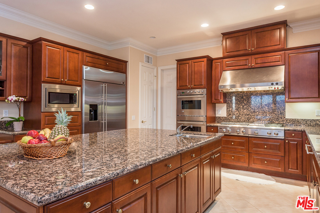 12090 Nelson Road Moorpark, CA 93021 - Photo 19 of 54 a kitchen with stainless steel appliances granite countertop a sink stove and cabinets