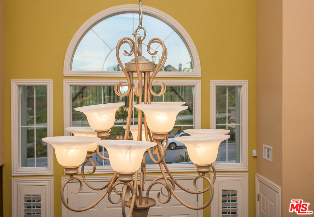 12090 Nelson Road Moorpark, CA 93021 - Photo 22 of 54 a view of a dining room with furniture a chandelier and wooden floor