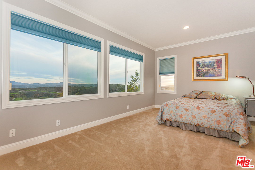 12090 Nelson Road Moorpark, CA 93021 - Photo 24 of 54 a bedroom with a large bed and a large window
