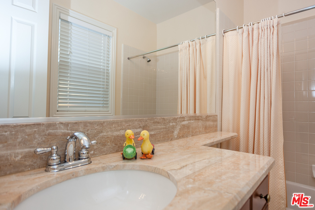12090 Nelson Road Moorpark, CA 93021 - Photo 28 of 54 a bathroom with a granite countertop sink and a mirror