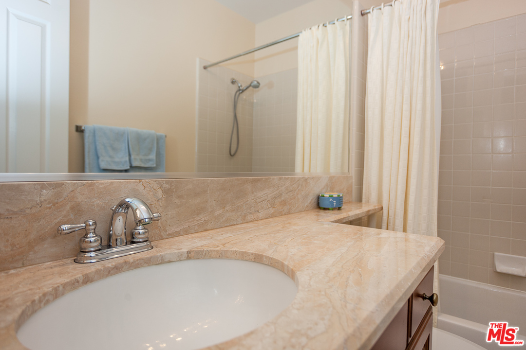 12090 Nelson Road Moorpark, CA 93021 - Photo 29 of 54 a bathroom with a granite countertop sink and a mirror