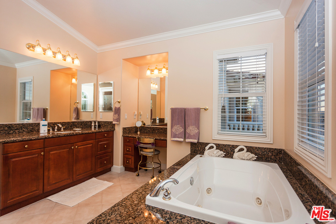 12090 Nelson Road Moorpark, CA 93021 - Photo 34 of 54 a bathroom with a tub a sink and a large window