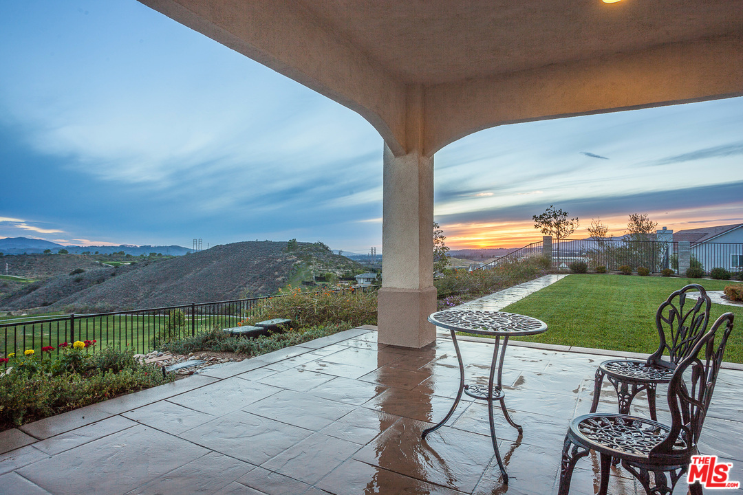 12090 Nelson Road Moorpark, CA 93021 - Photo 41 of 54 a view of chairs and table in patio with a yard