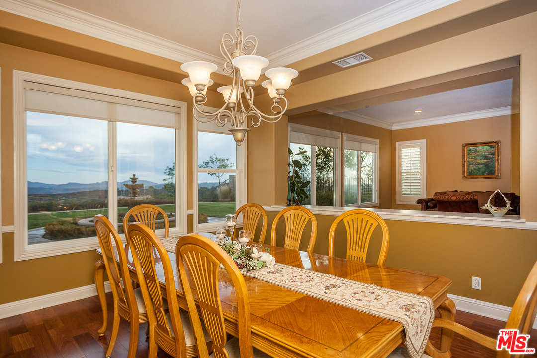 12090 Nelson Road Moorpark, CA 93021 - Photo 7 of 54 a view of a dining room with furniture large windows a chandelier and chandelier