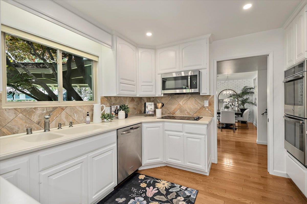 216 Montclair Road Los Gatos, CA 95032 - Photo 13 of 44 a kitchen with a sink stove and cabinets