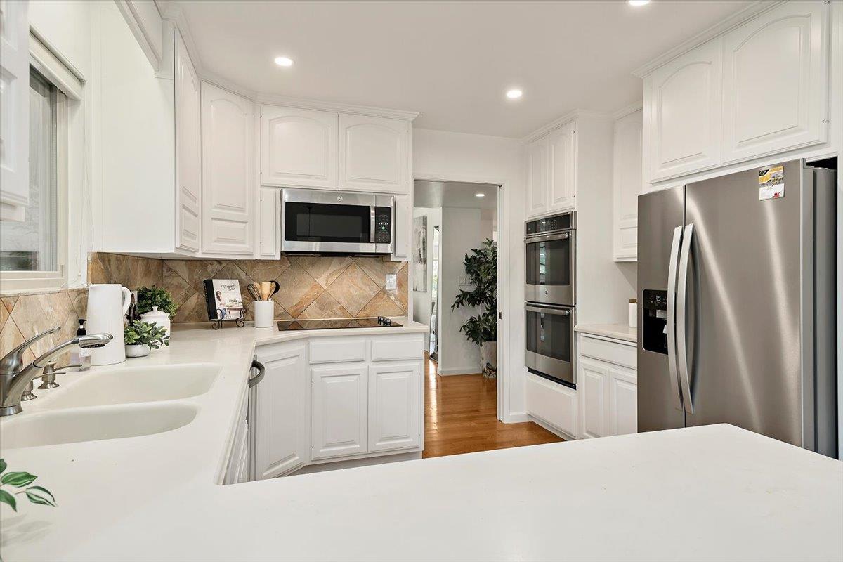 216 Montclair Road Los Gatos, CA 95032 - Photo 14 of 44 a kitchen with stainless steel appliances a refrigerator sink and microwave