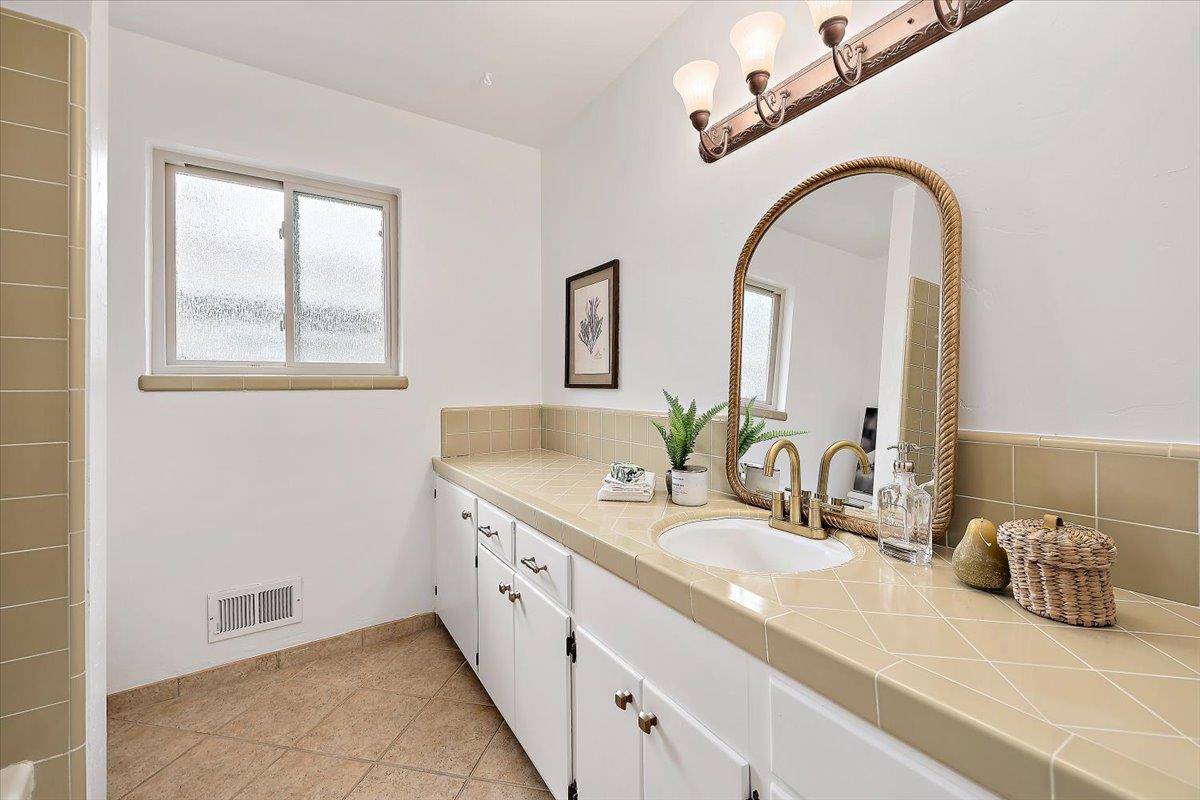 216 Montclair Road Los Gatos, CA 95032 - Photo 18 of 44 a bathroom with a double vanity sink and a mirror