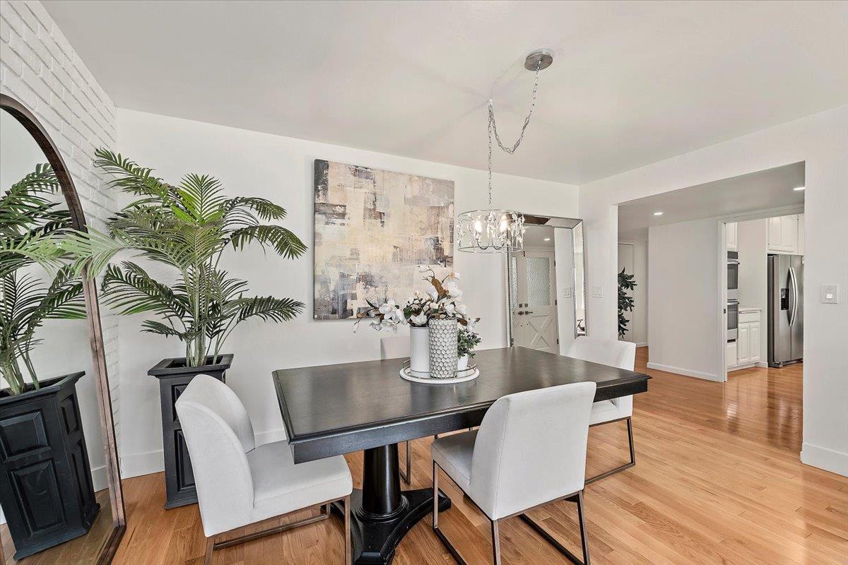 216 Montclair Road Los Gatos, CA 95032 - Photo 7 of 44 a dining room with furniture potted plants and wooden floor