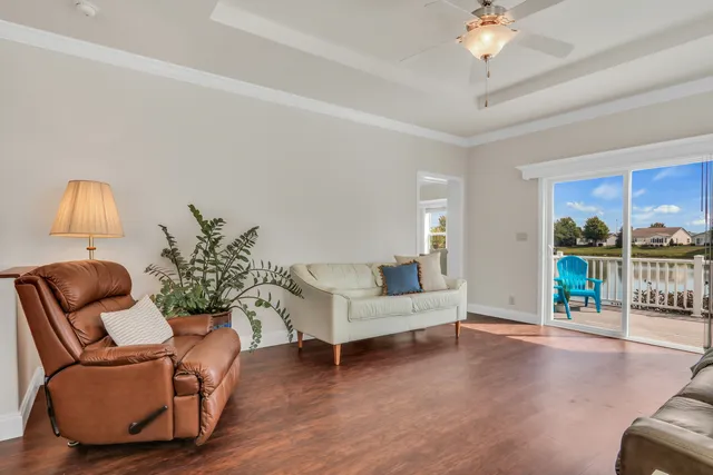a living room with furniture and a chandelier