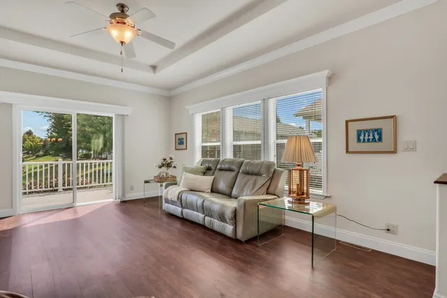 a living room with furniture and a window with wooden floor