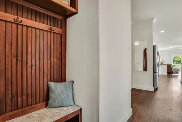 a view of a hallway with wooden floor and staircase