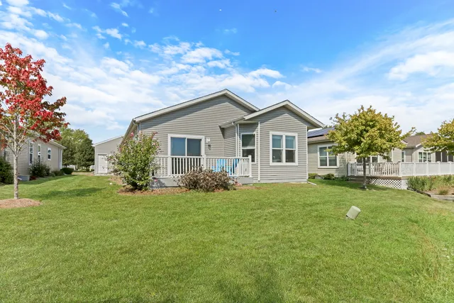 a backyard of a house with table and chairs