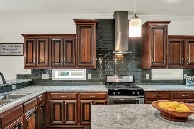 a kitchen with granite countertop a stove and a sink