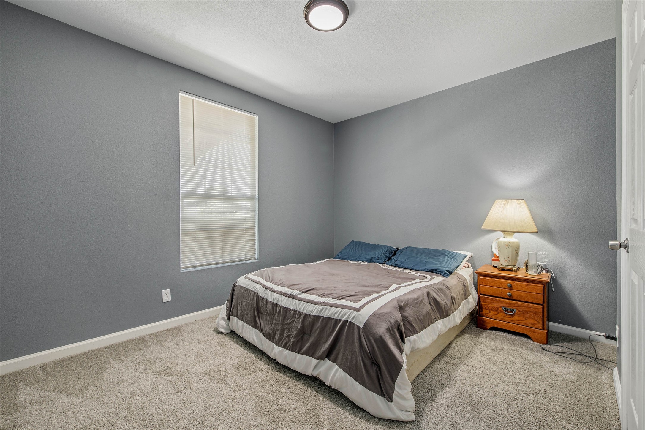 3876 Hummingbird Lane Bedias, TX 77831 - Photo 16 of 29 a bedroom with a bed and a window
