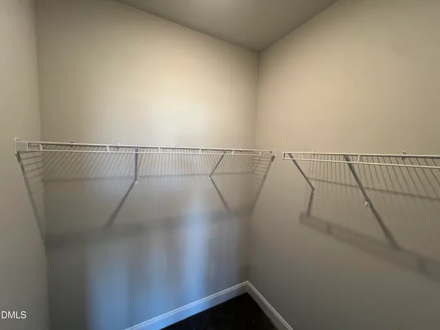 a view of an empty room with window and fireplace