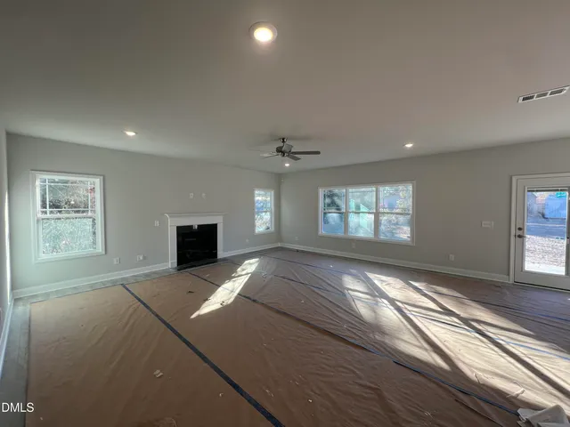 a view of a house with a big yard and a large tree