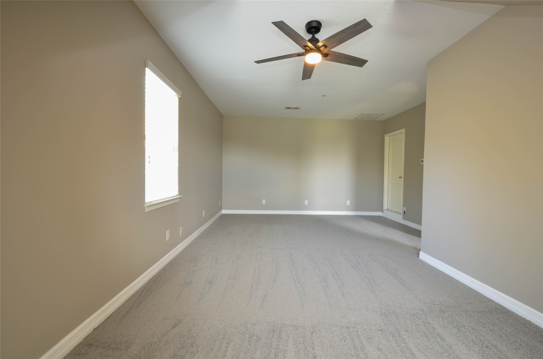 6125 Alleluia Trail Manvel, TX 77578 - Photo 17 of 25 an empty room with a window and a ceiling fan
