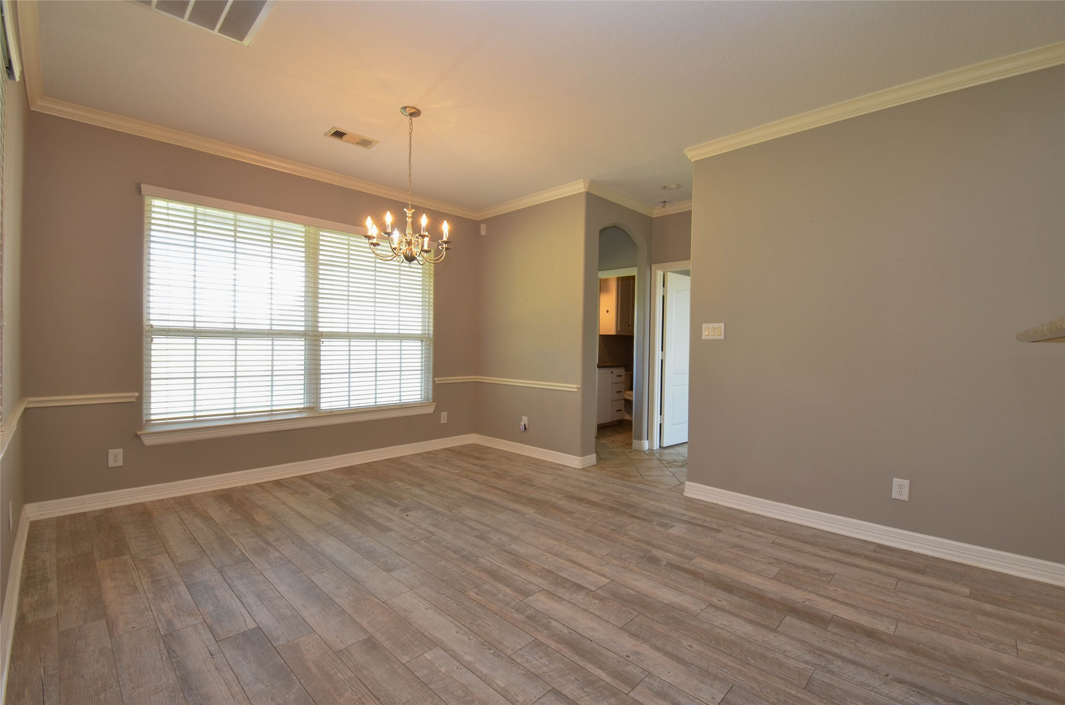 6125 Alleluia Trail Manvel, TX 77578 - Photo 21 of 25 an empty room with wooden floor and windows