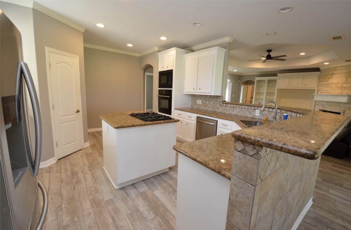 6125 Alleluia Trail Manvel, TX 77578 - Photo 3 of 25 a kitchen with stainless steel appliances granite countertop a sink stove and refrigerator
