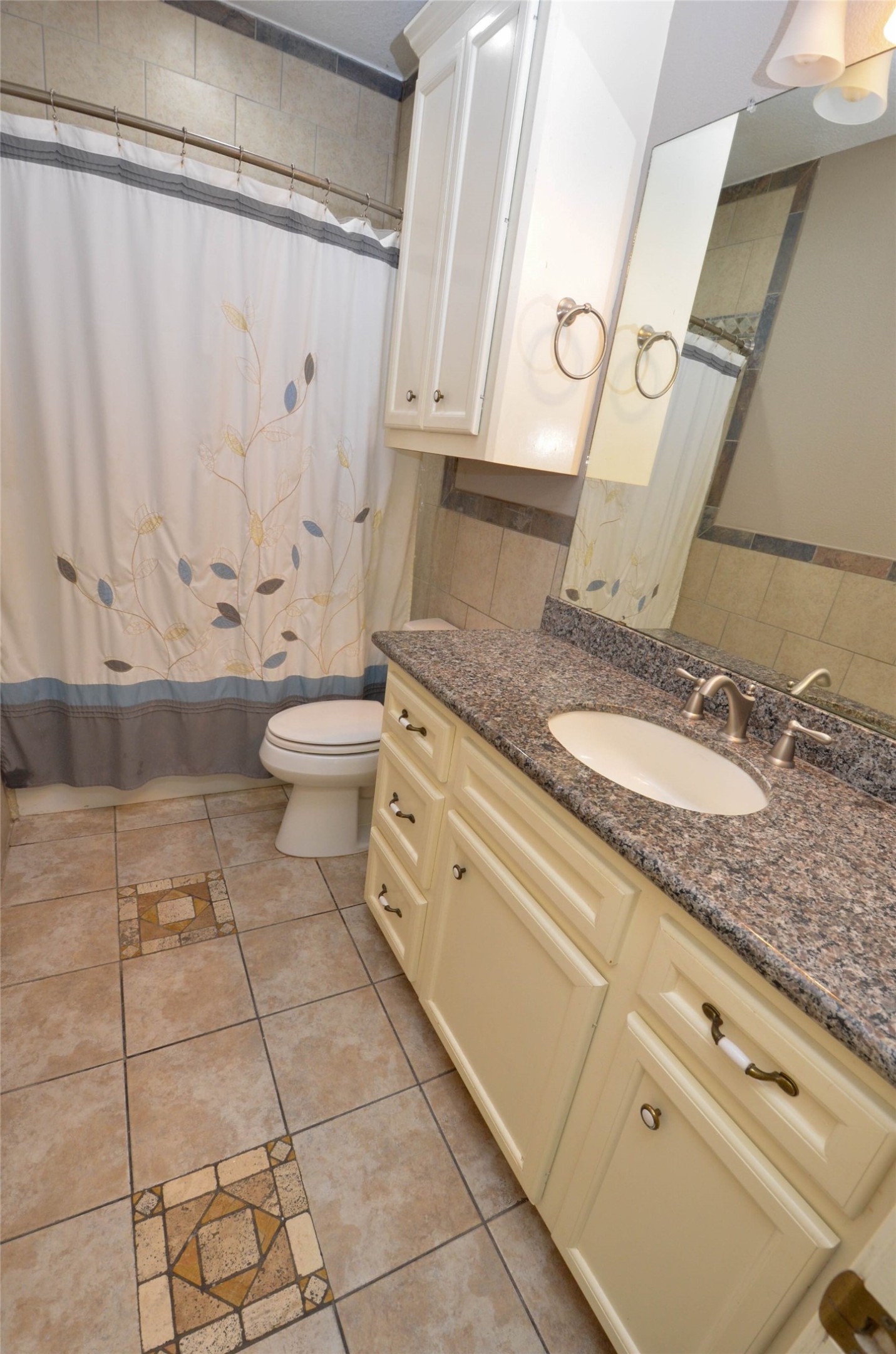 6125 Alleluia Trail Manvel, TX 77578 - Photo 9 of 25 a bathroom with a granite countertop sink a toilet and a mirror