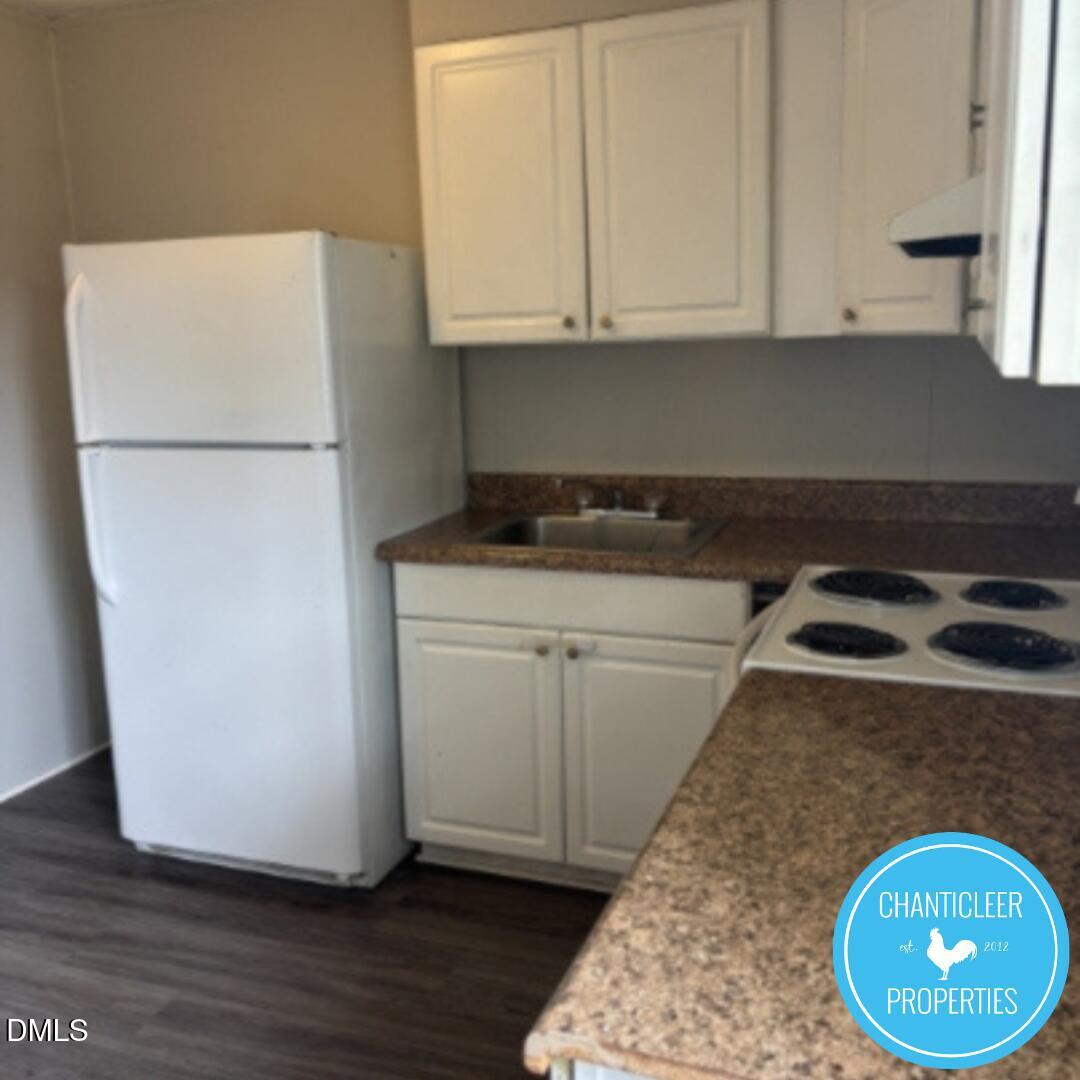 115 Florence Street, Unit 9 Graham, NC 27253 - Photo 3 of 14 a kitchen with a refrigerator and a stove