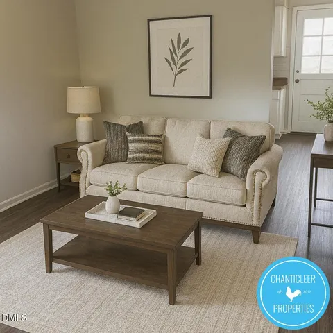 a living room with furniture a rug and a lamp