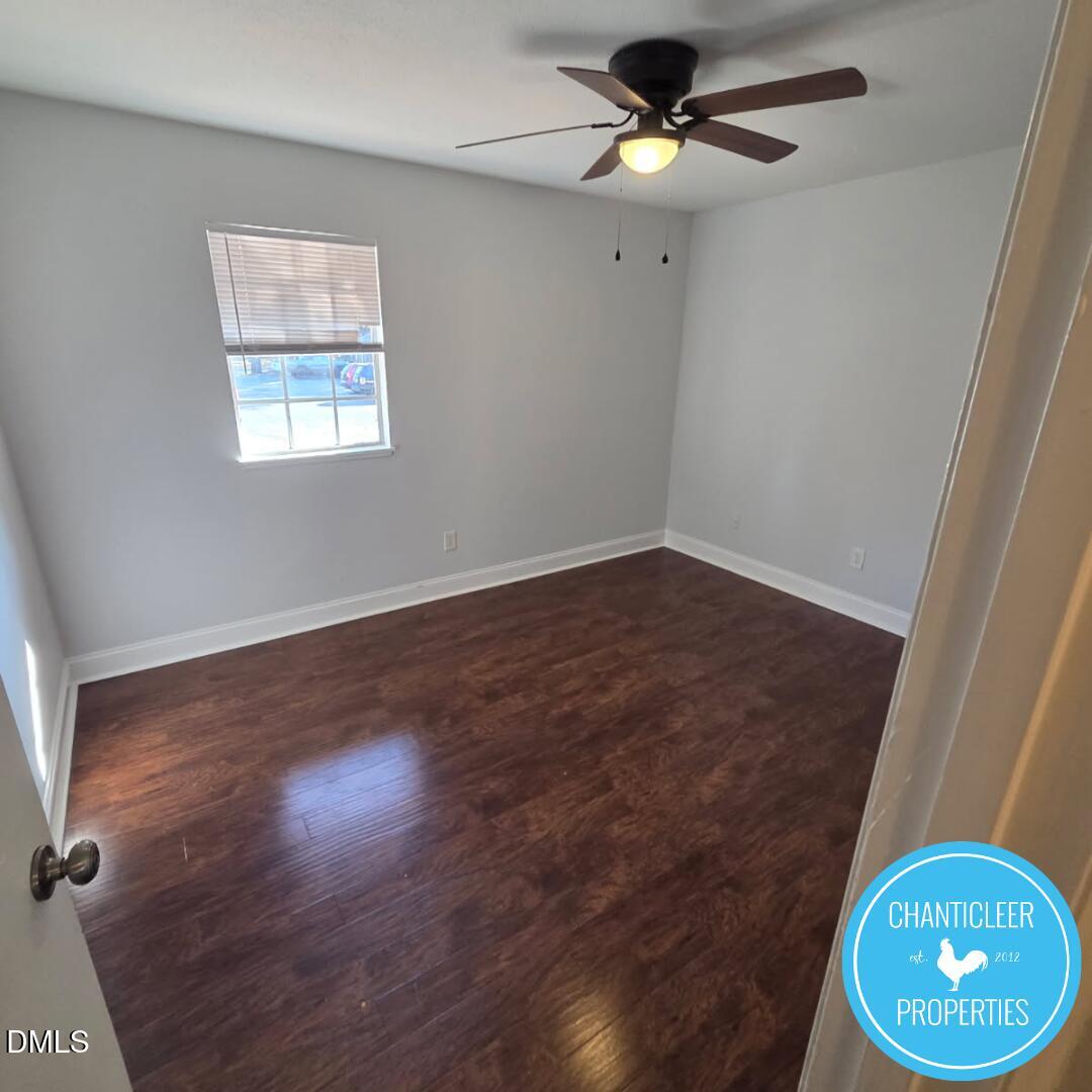 115 Florence Street, Unit 9 Graham, NC 27253 - Photo 6 of 14 an empty room with wooden floor fan and window