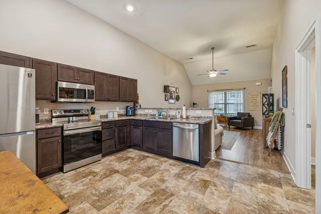 a kitchen with a sink stainless steel appliances and cabinets