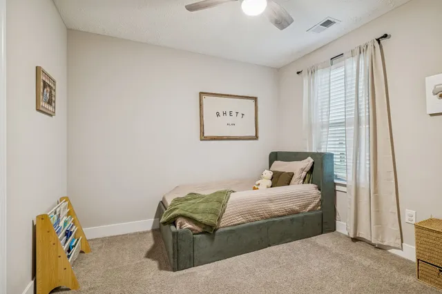 a bedroom with a bed and a window