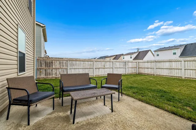 a view of a yard with furniture