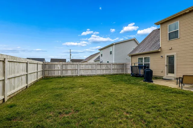 a view of a backyard with table and chairs