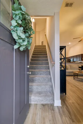 a view of entryway and hall with wooden floor