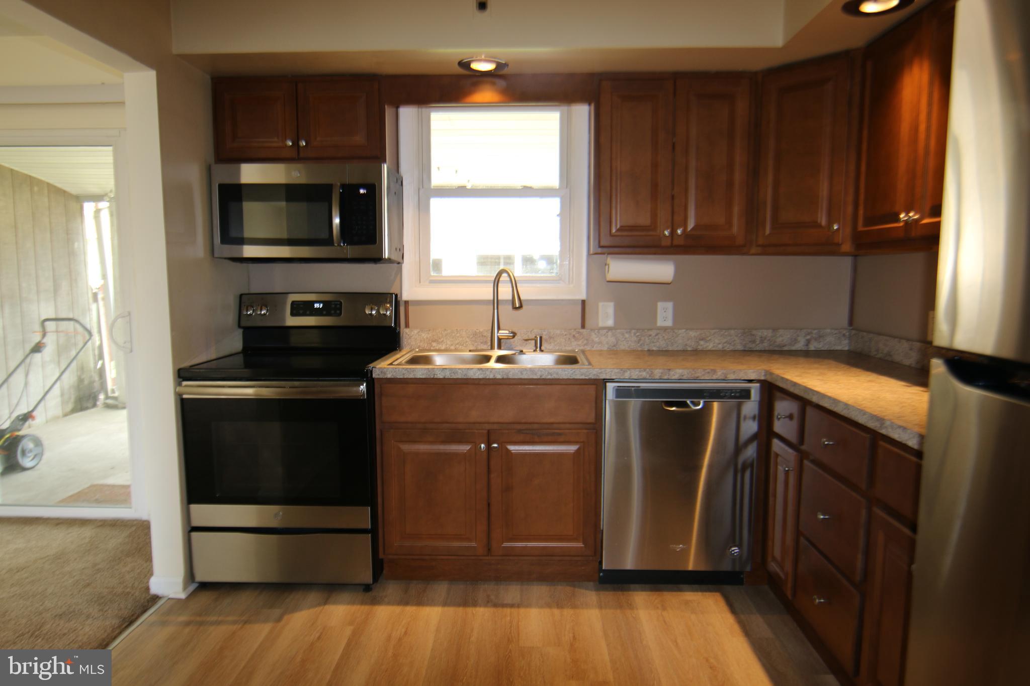2121 Market St Extension Middletown, PA 17057 - Photo 4 of 19 a kitchen with a sink stove and microwave