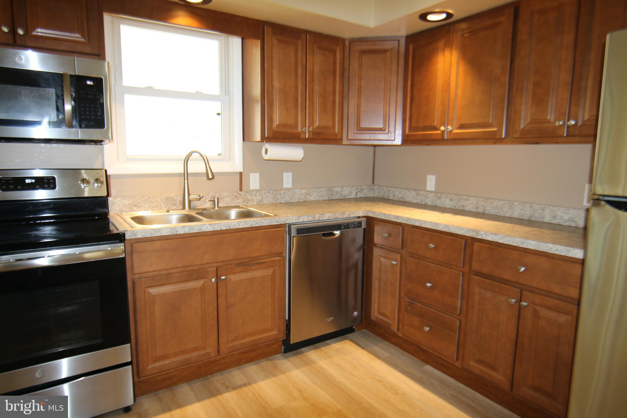 2121 Market St Extension Middletown, PA 17057 - Photo 6 of 19 a kitchen with a sink stove and cabinets