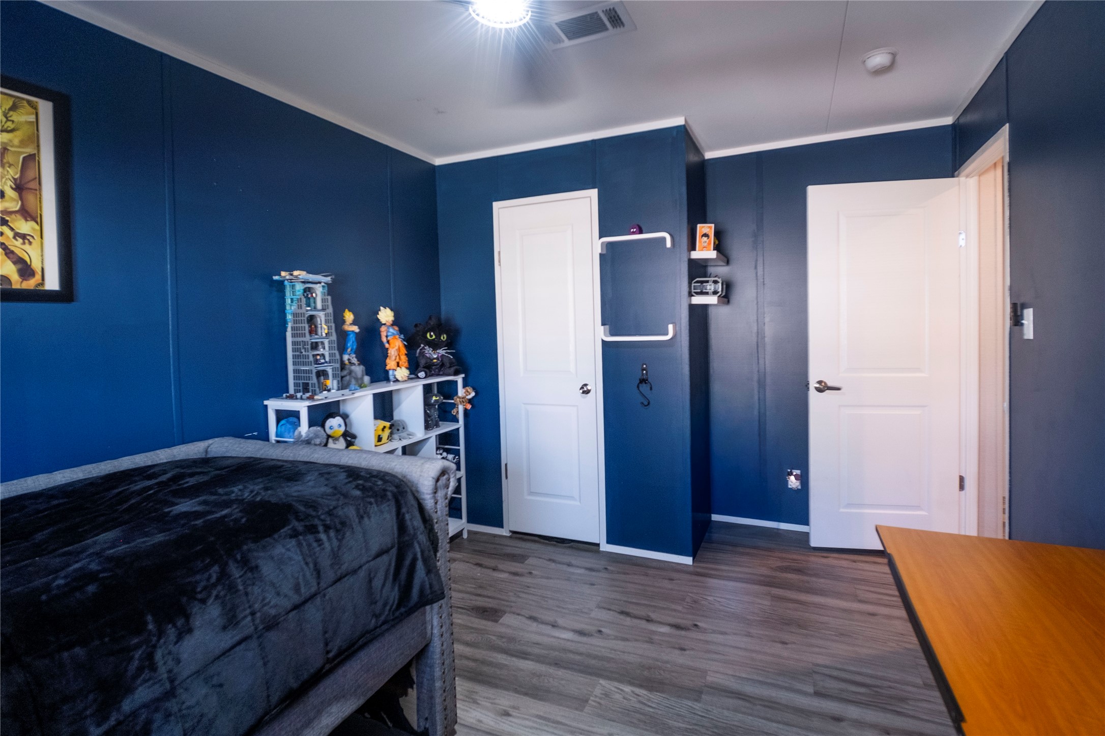5402 Five Oaks Drive Spring, TX 77389 - Photo 17 of 20 a bedroom with a bed and wooden floor