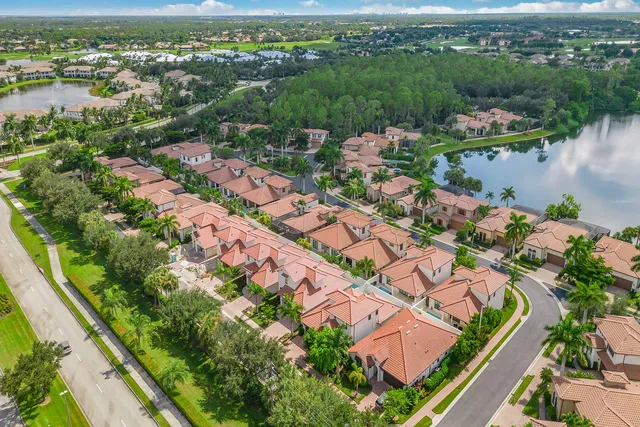 an aerial view of lake and residential houses with outdoor space
