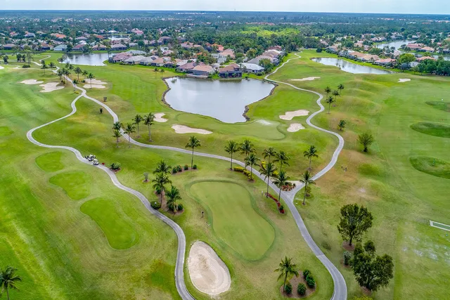 an aerial view of a residential houses with outdoor space and swimming pool