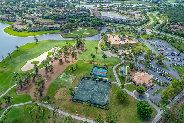 an aerial view of a house with a garden and lake view