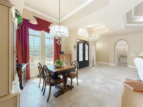 a kitchen with stainless steel appliances granite countertop a stove a refrigerator a oven a sink a island with a dining table and chairs