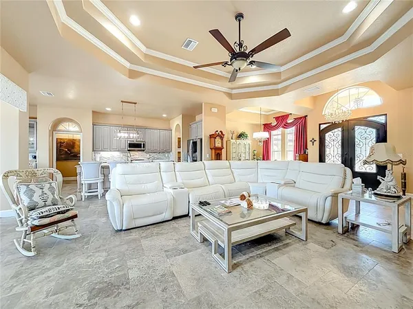 a large kitchen with stainless steel appliances kitchen island granite countertop a table and chairs in it