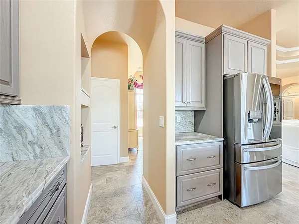 a spacious bathroom with a granite countertop sink a mirror and a shower