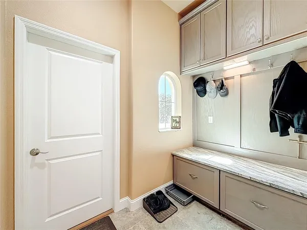 a view of a house with a big yard potted plants and large tree