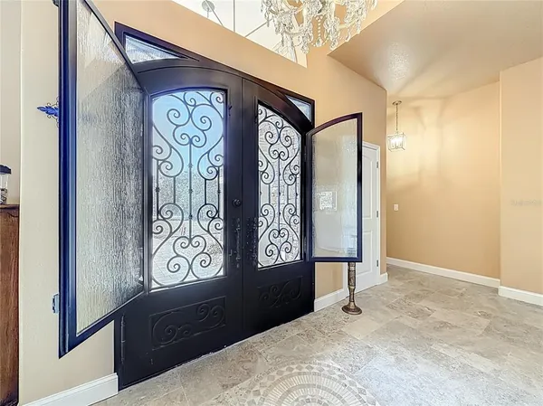 a view of a dining room with furniture and a chandelier