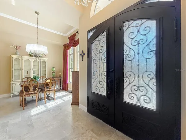 a living room with furniture fireplace and a chandelier