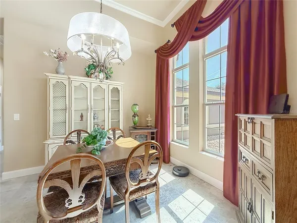 a living room with furniture a ceiling fan and a large window