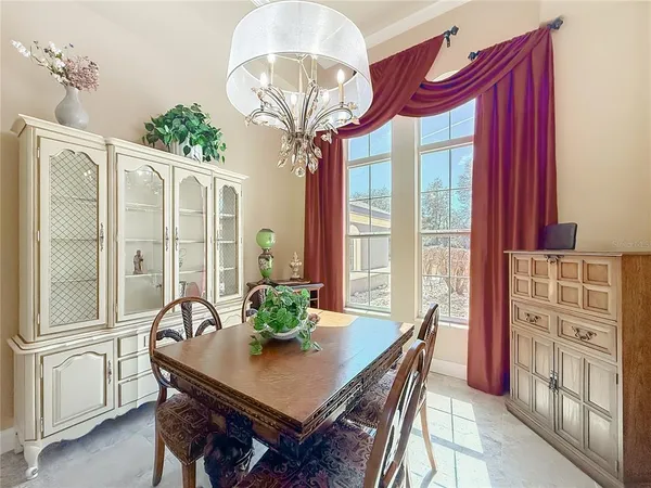 a living room with furniture a clock and a ceiling fan