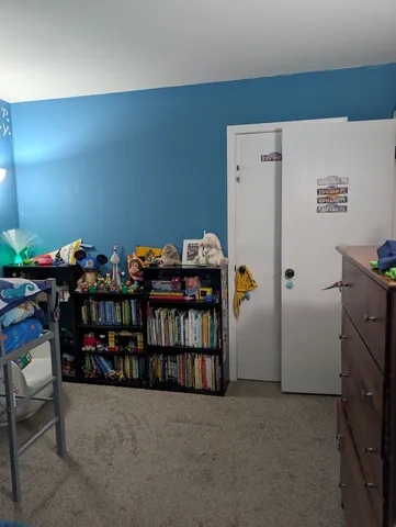 a room with lots of furniture and refrigerator